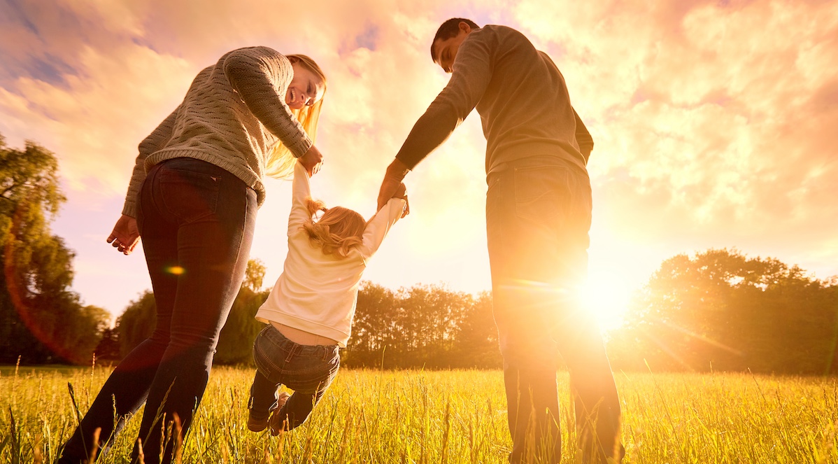 Parents hold the baby’s hands. Happy family in the park evening light. The lights of a sun. Mom, dad and baby happy walk at sunset. The concept of a happy family. sona homes in fredricksburg va